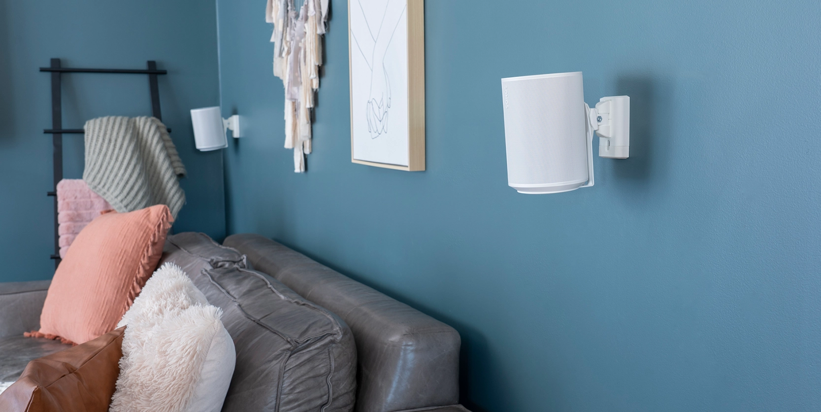 Lifestyle shot featuring WSWME11 Adjustable Speaker Wall Mounts in white